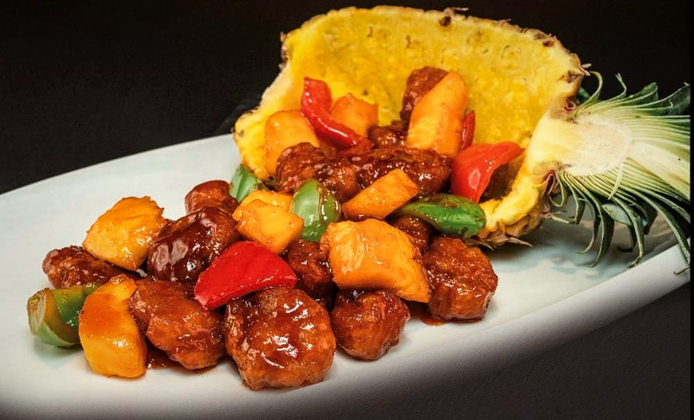 Sweet and sour pork served in a pineapple